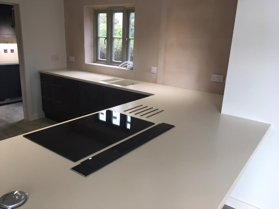 Corian Bone island and sink worktop, hot rod bars, downdraft and hob, pop up and utility room kitchen worksurfaces